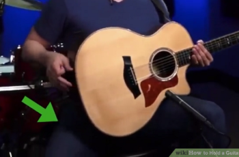 how to hold a guitar correctly